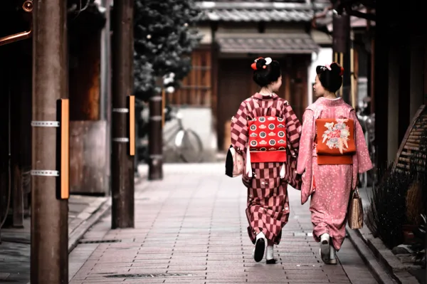 Two women in kimono walking and talking