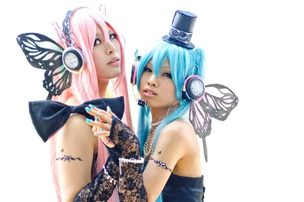 Two cosplayers wearing headphones on a white background