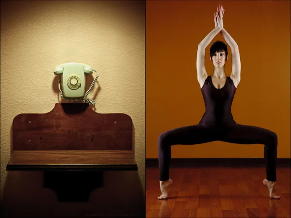 Dancer in a symmetric position beside a similarly shaped telephone stand
